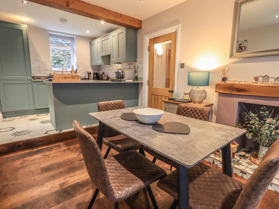 A kitchen with a dining table and chairs at West View in Leasgill near Milnthorpe