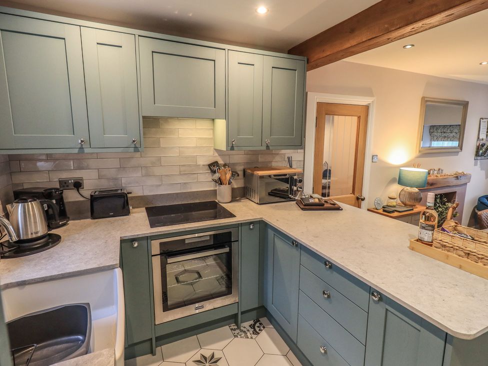 A kitchen with cabinets and appliances at West View Leasgill near Milnthorpe