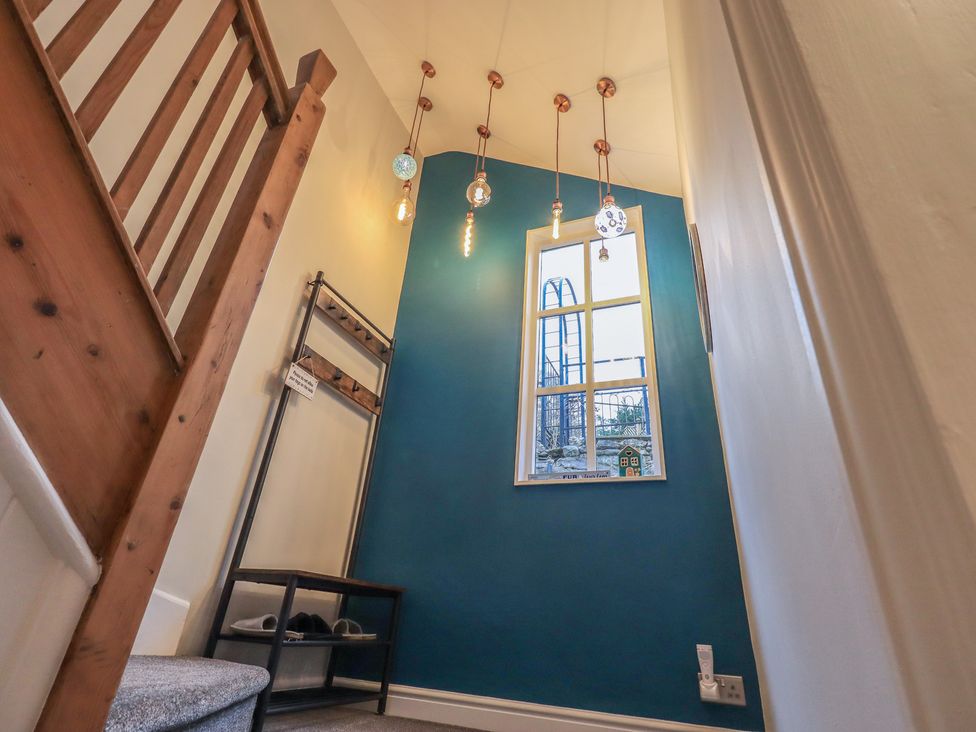 A hallway with a staircase and coat rack at West View Leasgill near Milnthorpe