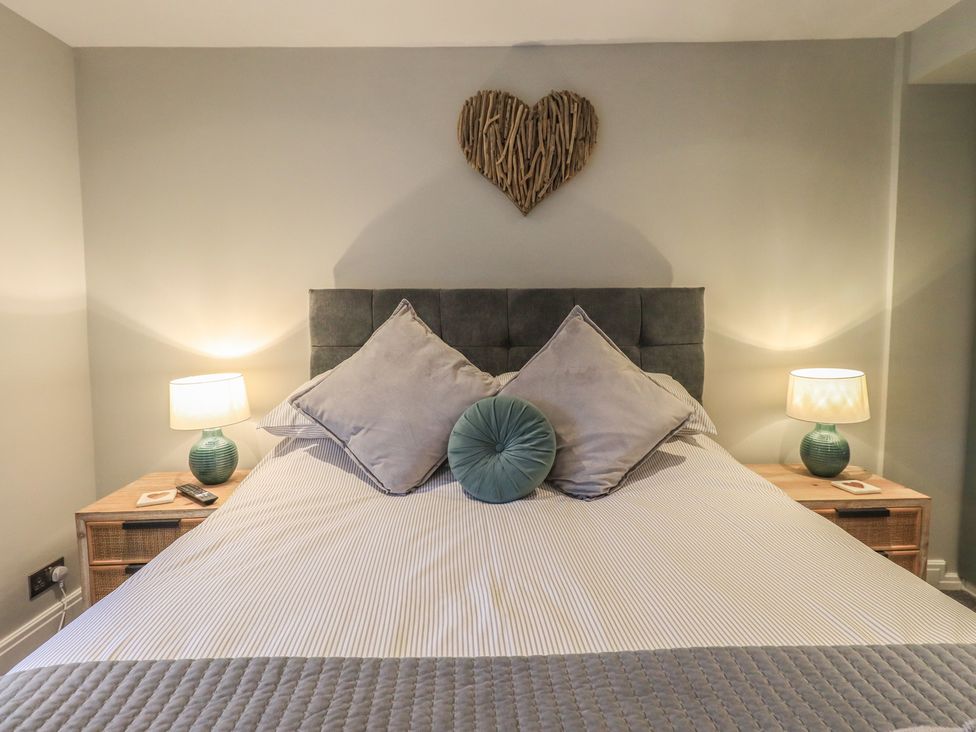 A bedroom with a bed and bedside lamps at West View Leasgill near Milnthorpe