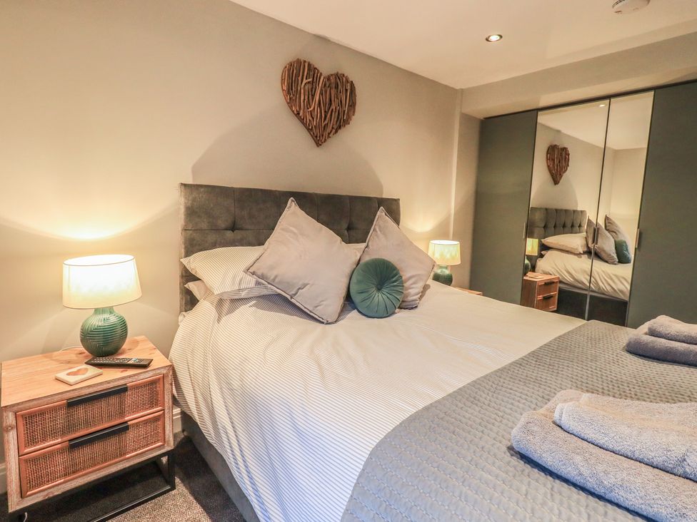 A bedroom with a bed and bedside table at West View in Leasgill near Milnthorpe