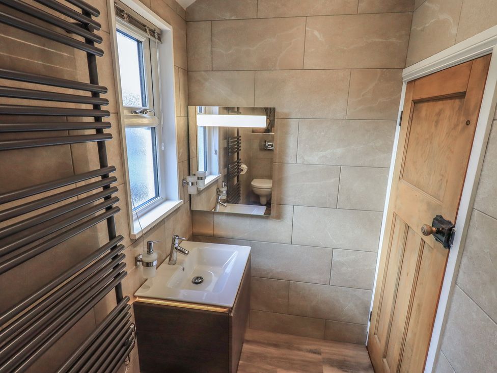 A bathroom with sink and mirror at West View in Leasgill near Milnthorpe