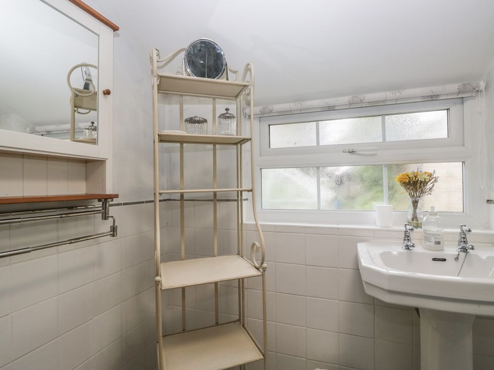 A bathroom with shelf and wash basin at Bay Tree Cottage in Ambleside