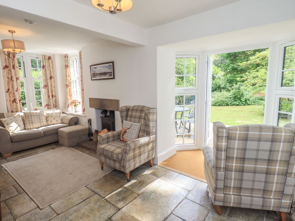 A living room with sofa and armchairs at The Old Post House at Low Stott Park near Newby Bridge