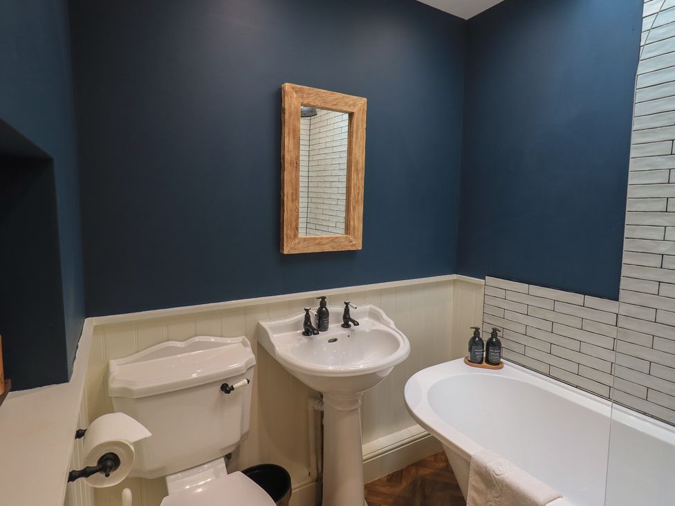 A bathroom with a toilet, sink, and bathtub at The Old Post House at Low Stott Park near Newby Bridge