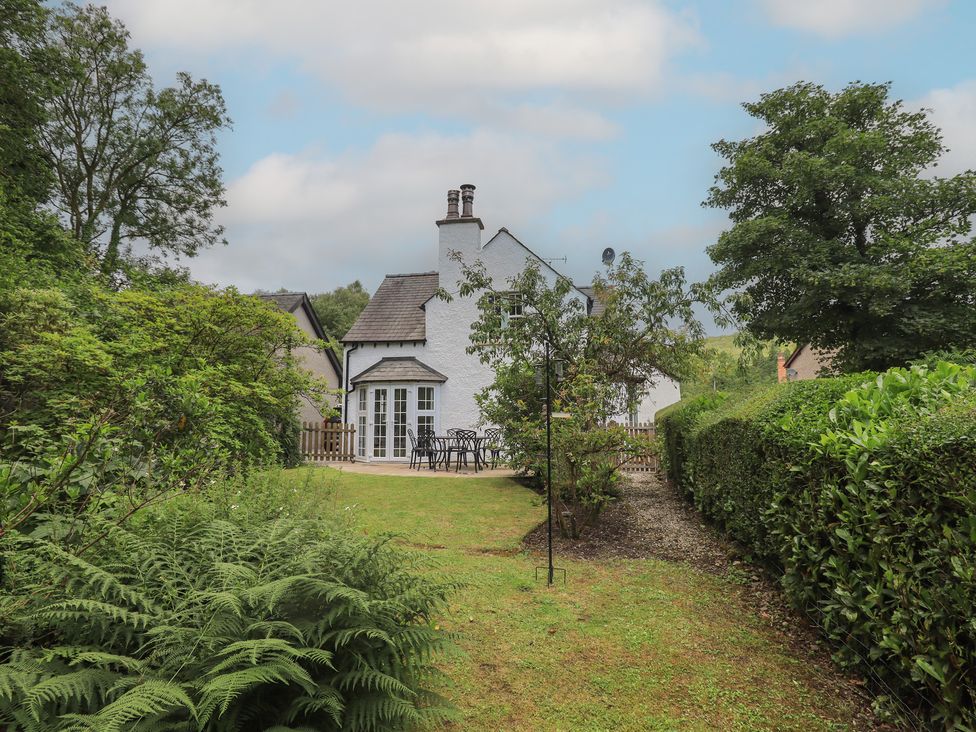 A house with a garden and seating area at The Old Post House at Low Stott Park near Newby Bridge