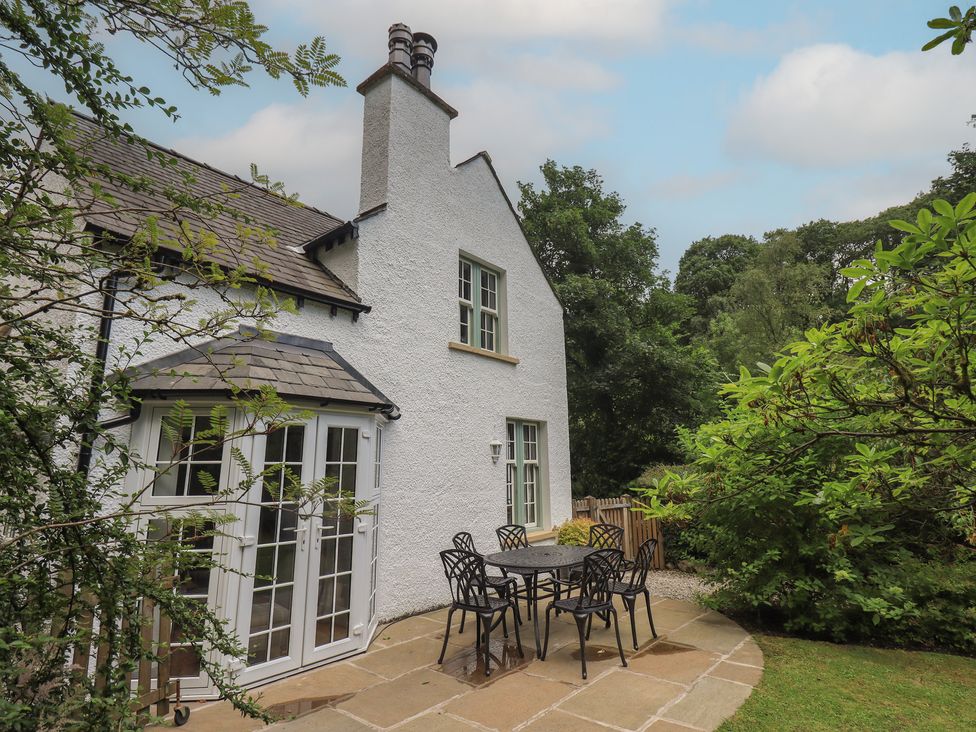 An outdoor area with a table and chairs at The Old Post House at Low Stott Park near Newby Bridge
