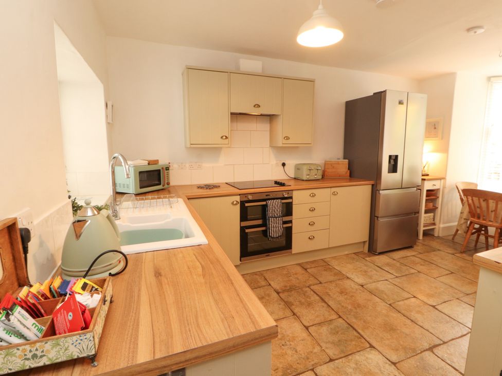 A kitchen with appliances and countertop space at The Old Post House at Low Stott Park near Newby Bridge