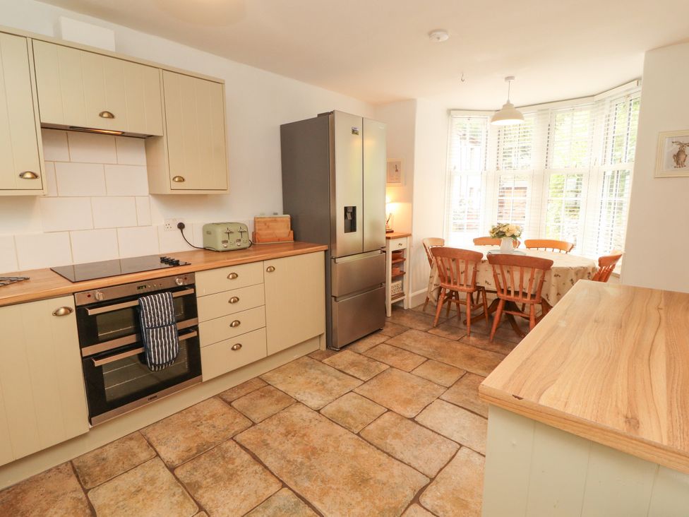 A kitchen with appliances and a dining area at The Old Post House at Low Stott Park near Newby Bridge