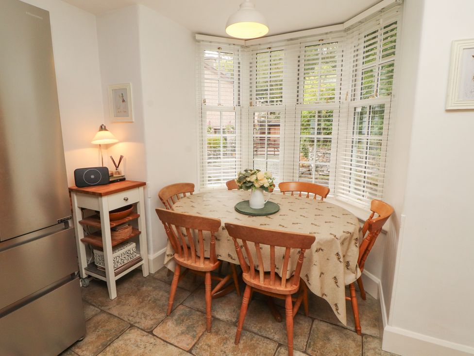 A dining room with a table and chairs at The Old Post House at Low Stott Park near Newby Bridge