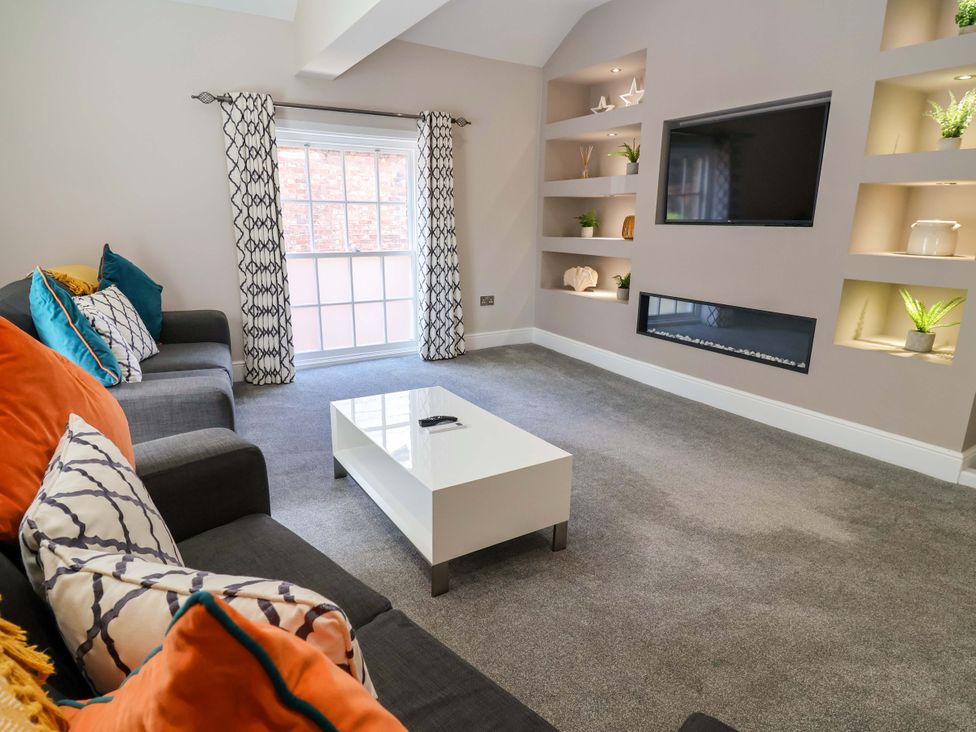 A living room with a sofa and coffee table at Carriage House in Capesthorne near Chelford