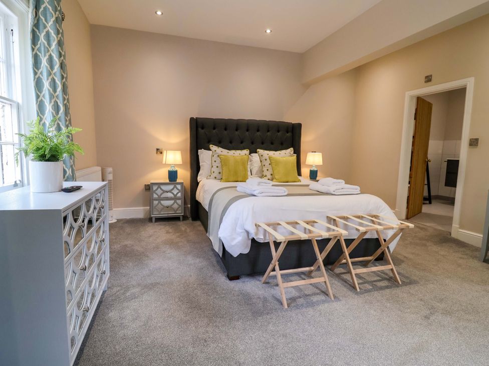 A bedroom with a bed and a side table at Carriage House in Capesthorne near Chelford