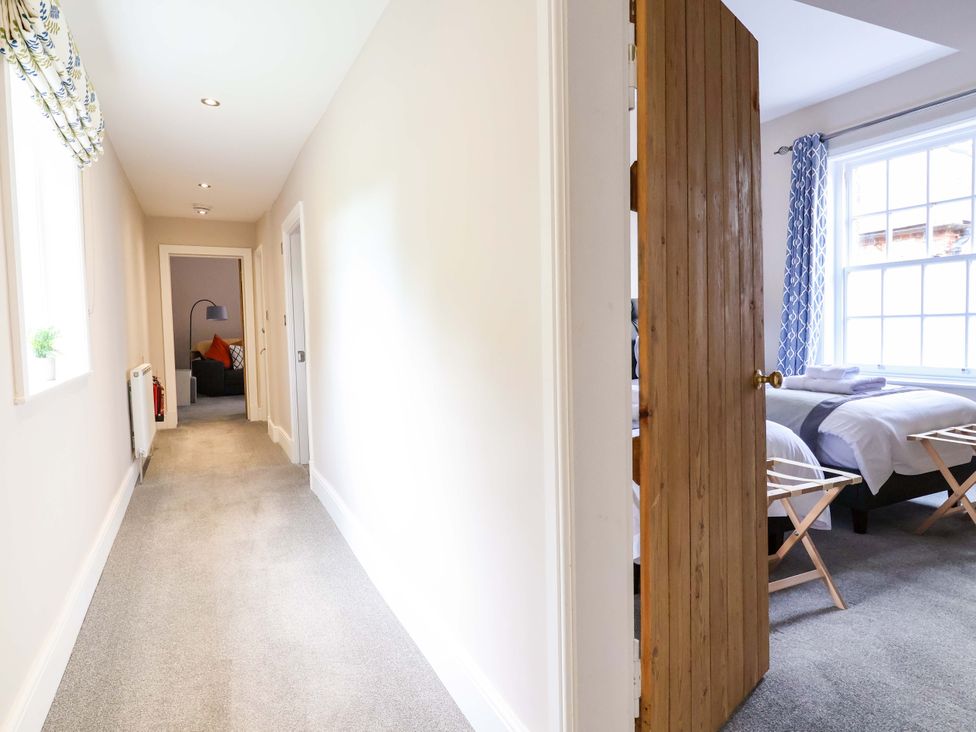 A hallway with a door to a bedroom at Carriage House in Capesthorne near Chelford
