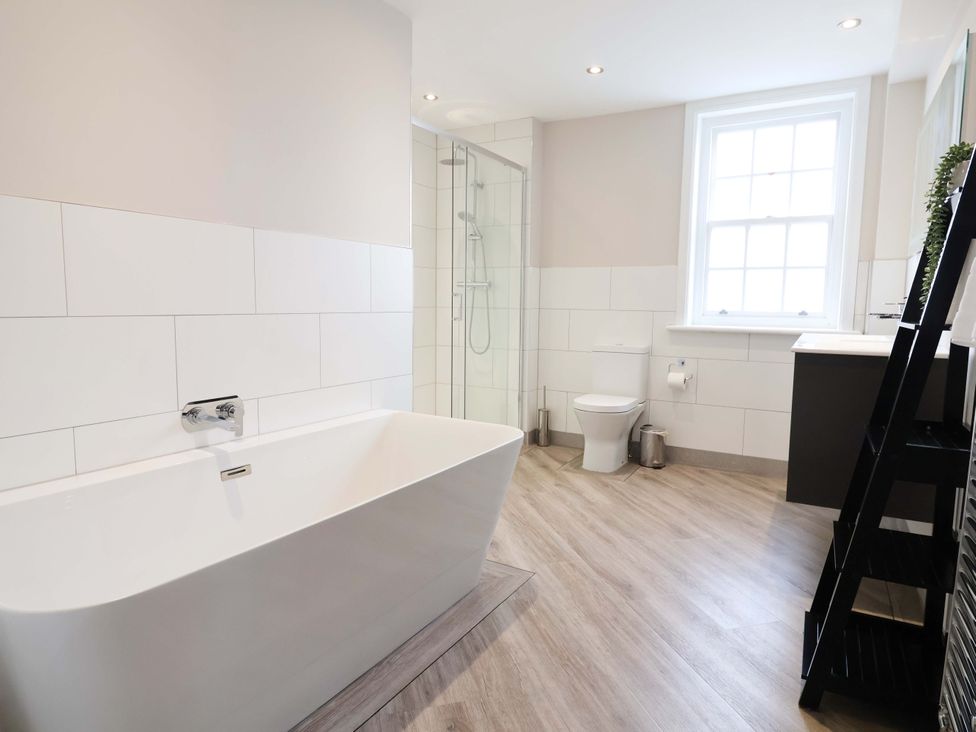 A bathroom with a bathtub, shower, toilet, and sink at Carriage House in Capesthorne near Chelford