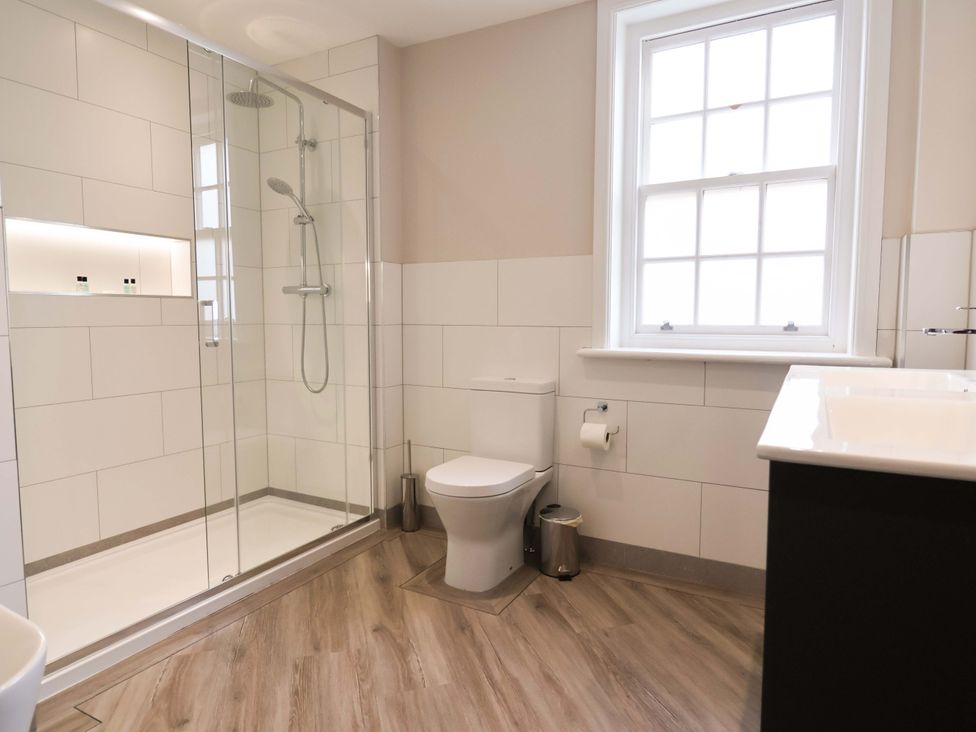A bathroom with a shower, toilet, and sink at Carriage House in Capesthorne near Chelford