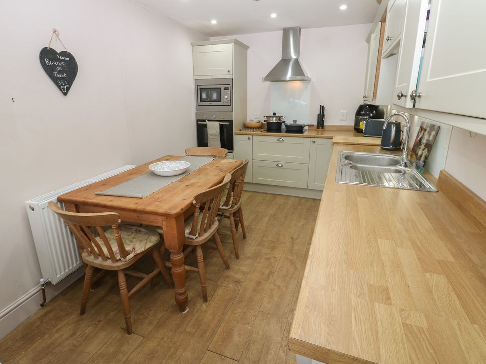 A kitchen with a dining table and appliances at Banklands in Barnard Castle