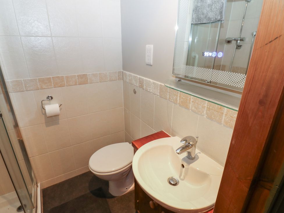 A bathroom with a shower, sink, and toilet at Banklands in Barnard Castle