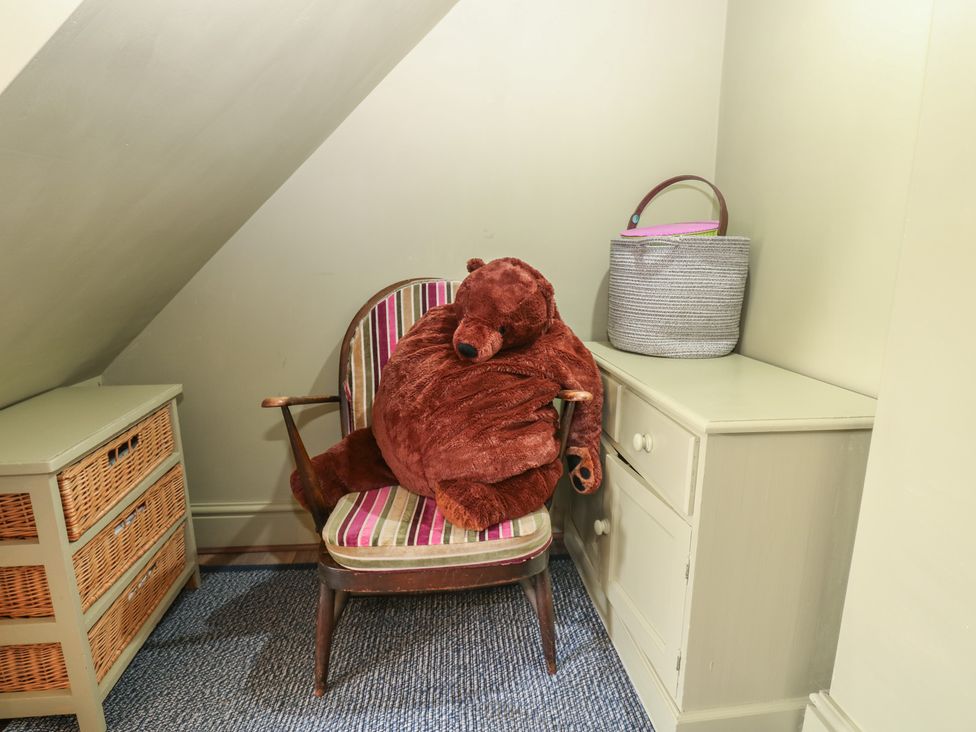 A nook with a chair and a stuffed bear at Banklands Mickleton, Teesdale