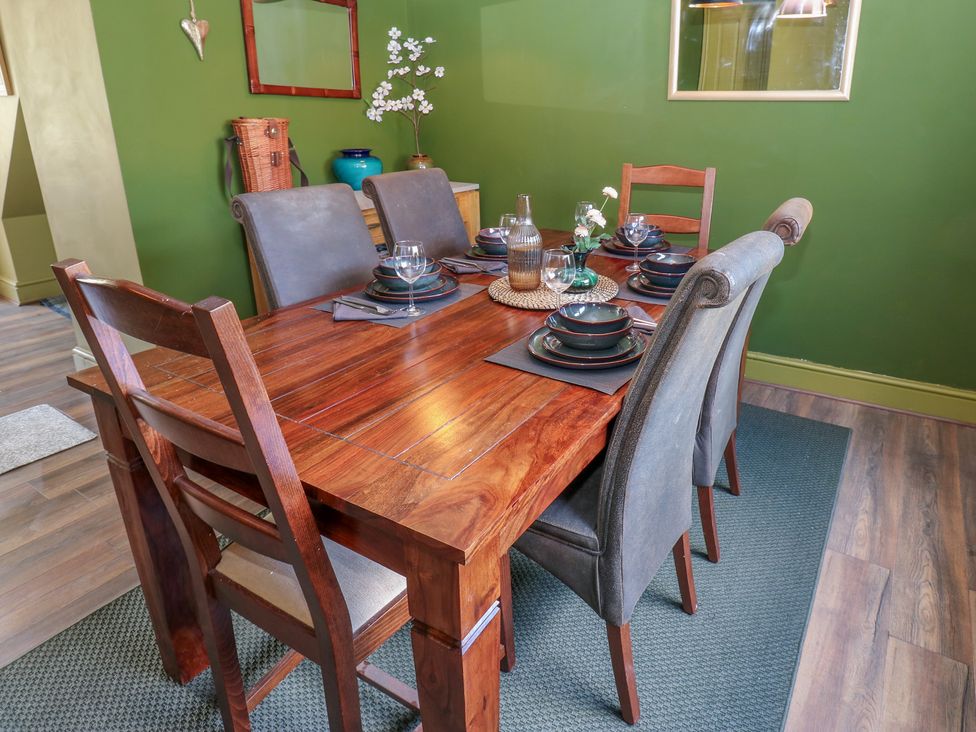 A dining room with a wooden table and chairs at Banklands in Mickleton, Teesdale