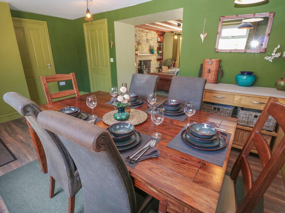 A dining room with a table set for dinner at Banklands in Mickleton, Teesdale