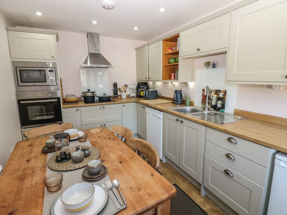A kitchen with a dining table and cooking appliances at Banklands Mickleton, Teesdale