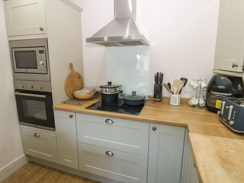 A kitchen with a stove, oven, and microwave at Banklands in Mickleton, Teesdale
