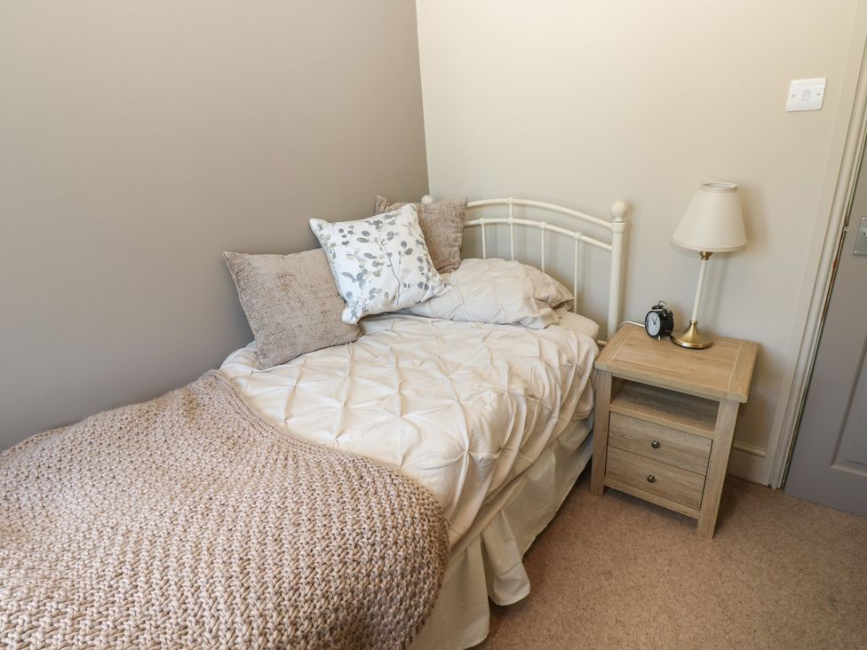A bedroom with a bed and nightstand at Banklands in Mickleton, Teesdale