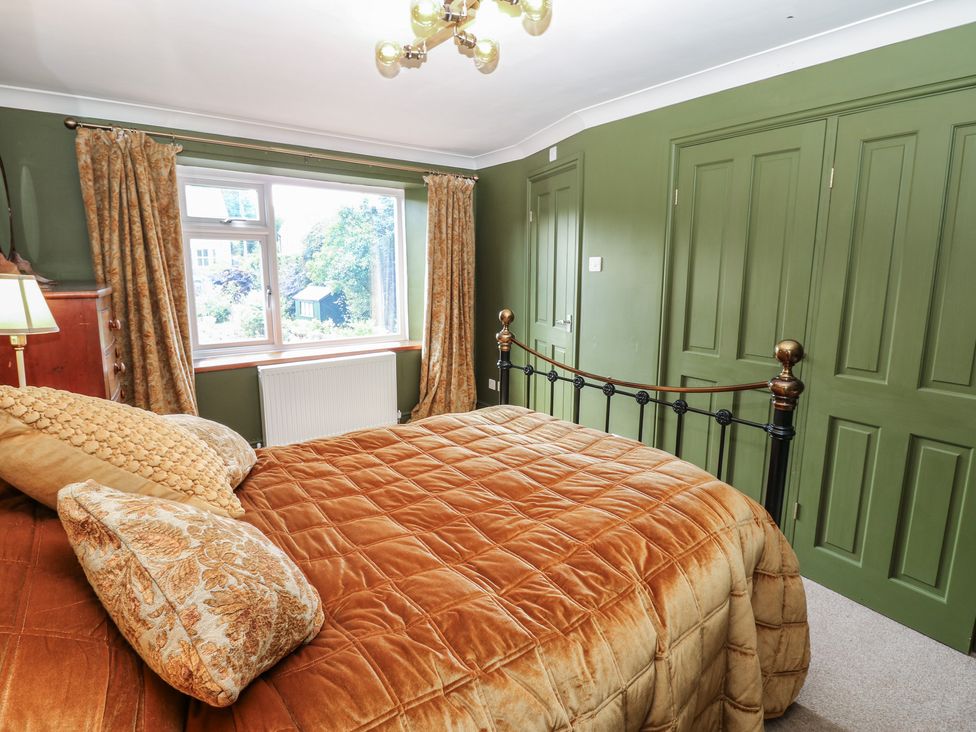 A bedroom with a bed and curtains at Banklands in Mickleton, Teesdale