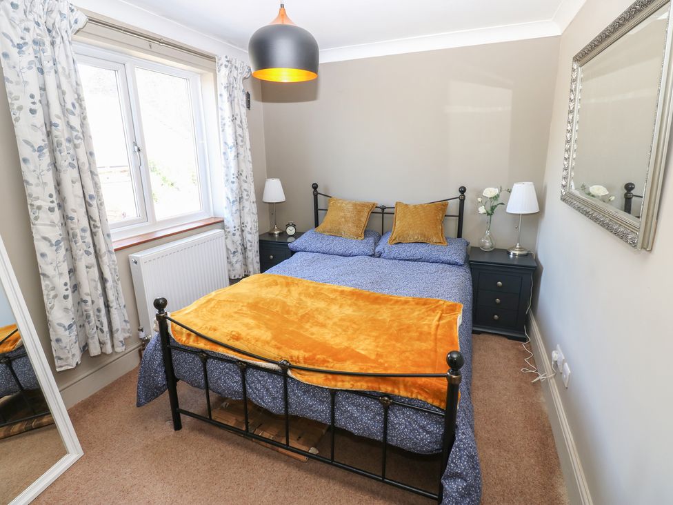 A bedroom with a bed and bedside table at Banklands in Mickleton, Teesdale