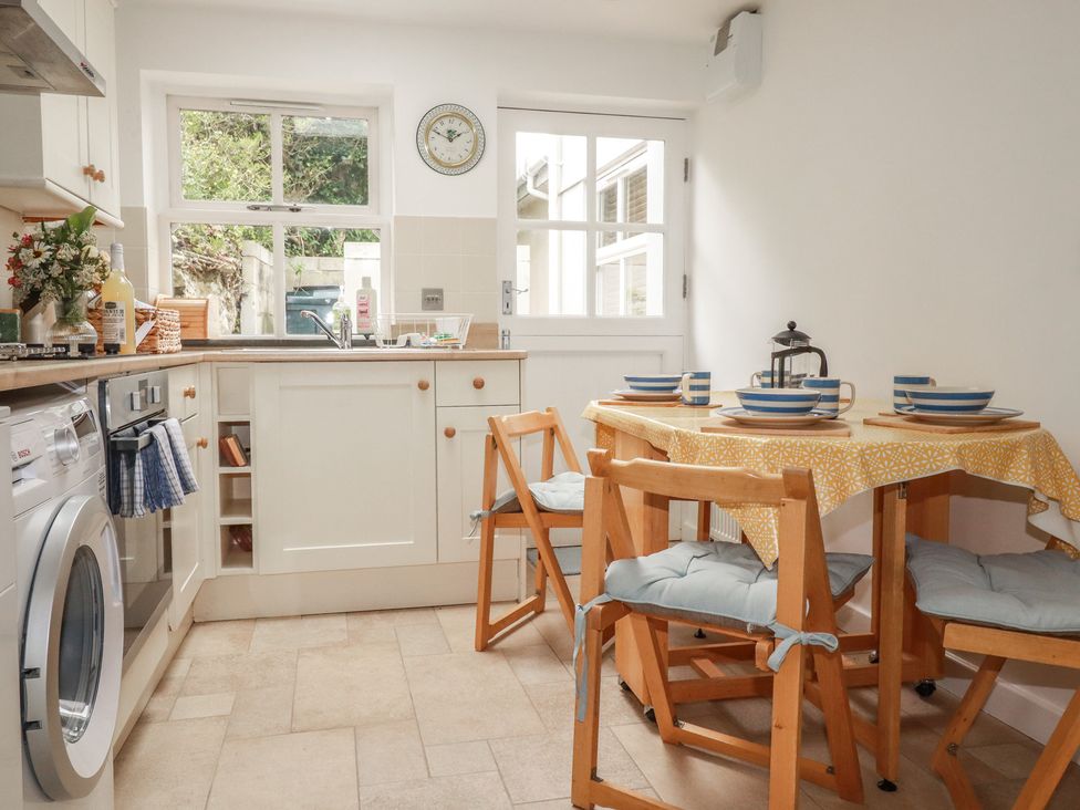 A kitchen with a table and chairs at 15 Boscaswell Downs Pendeen