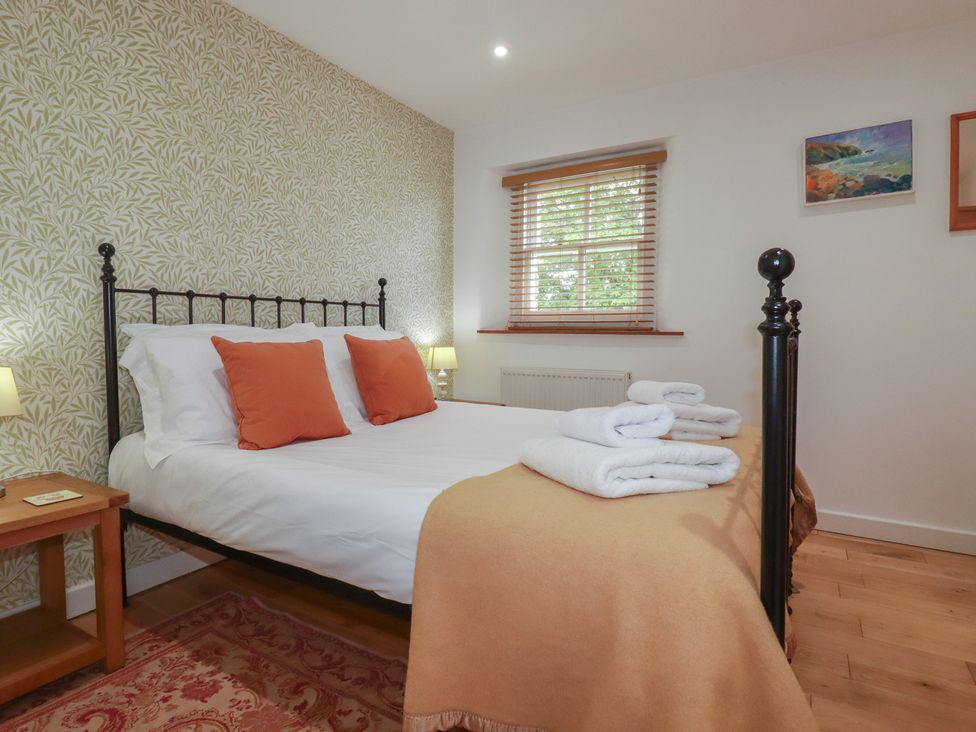 A bedroom with a bed and towels at 15 Boscaswell Downs Pendeen