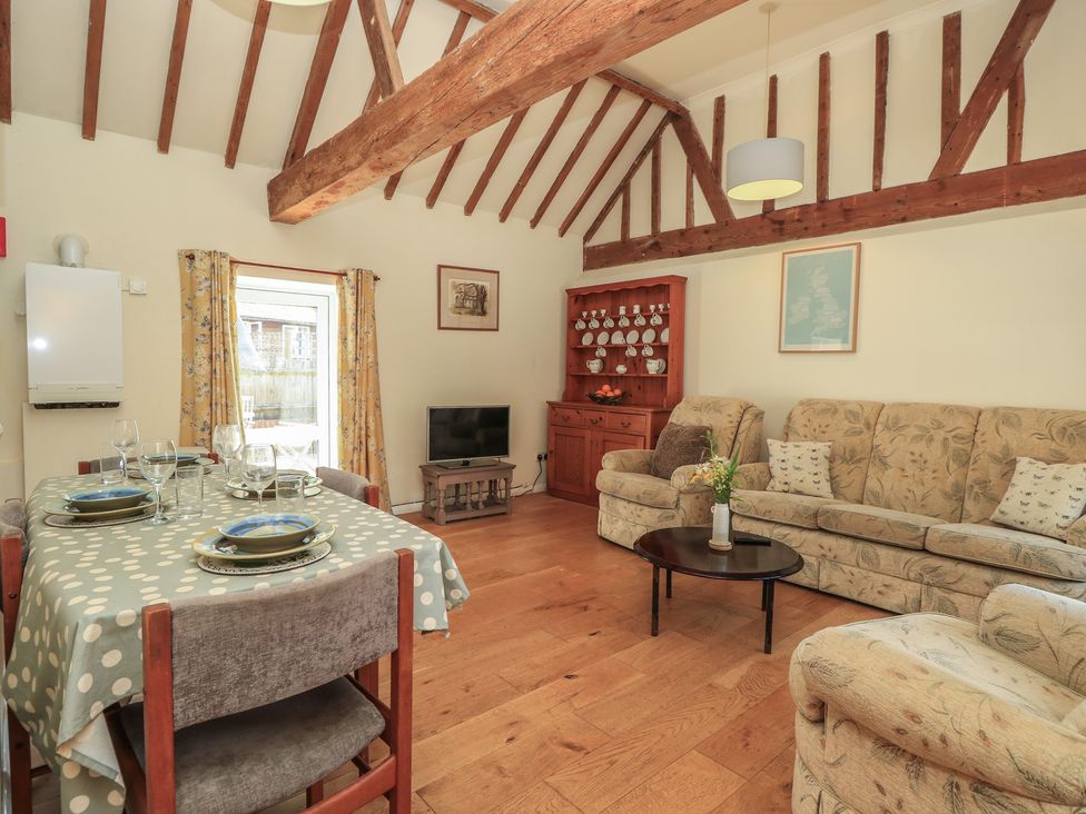 A living room with a dining table and sofa at Byre Cottage 3 Sullington near Storrington