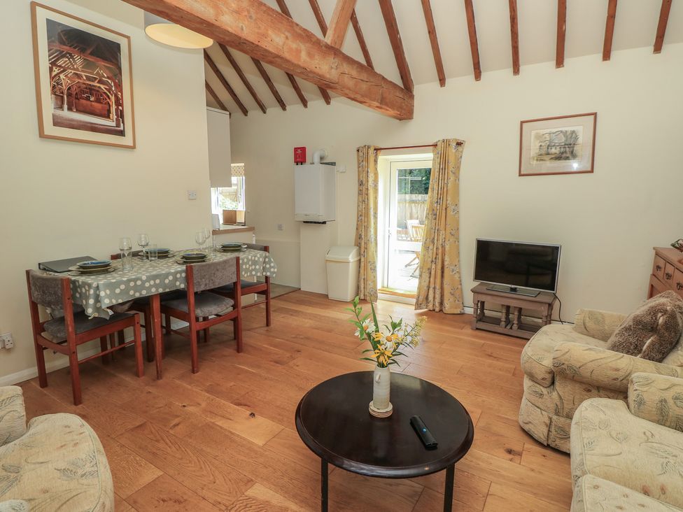 A living room with a dining table and sofa at Byre Cottage 3 Sullington near Storrington