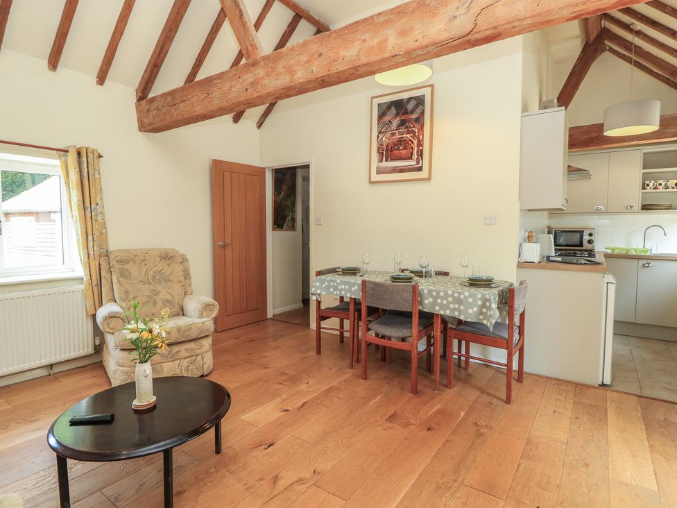 A dining room with a table and chairs at Byre Cottage 3 Sullington near Storrington