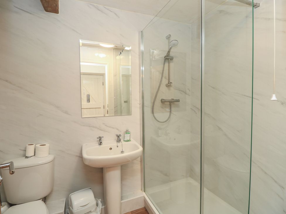 A bathroom with a shower and sink at Byre Cottage 3 Sullington near Storrington