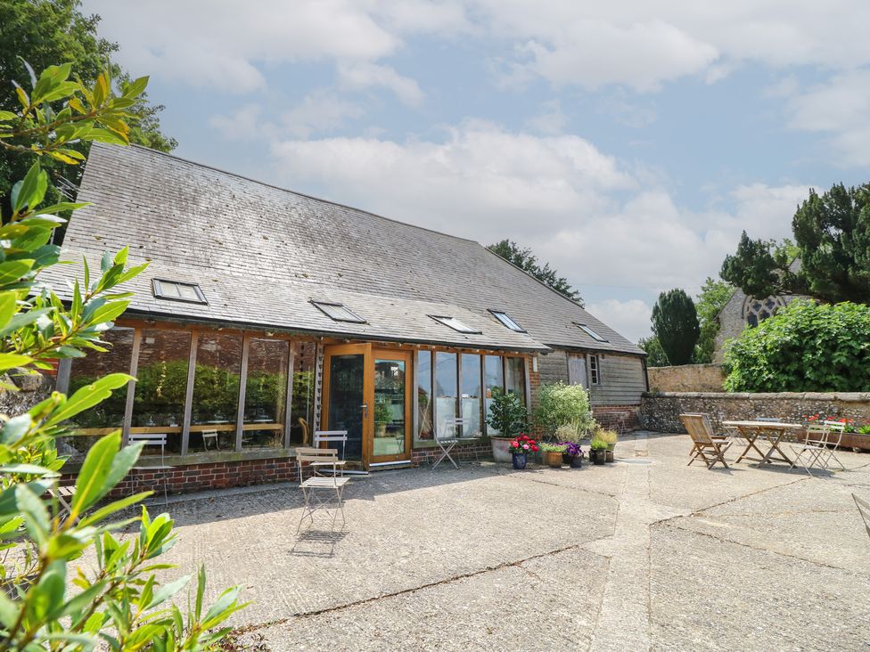 An outdoor area with furniture and plants at Byre Cottage 3 Sullington near Storrington