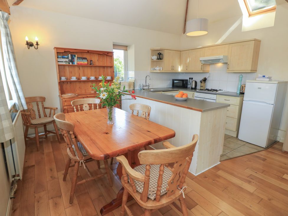 A kitchen with a dining table and chairs at Byre Cottage 2 Sullington near Storrington
