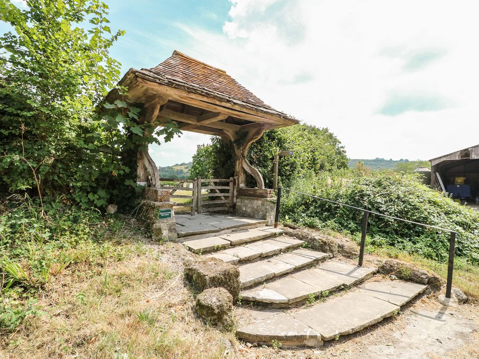 A gate with a canopy and steps outside at Byre Cottage 2 Sullington near Storrington