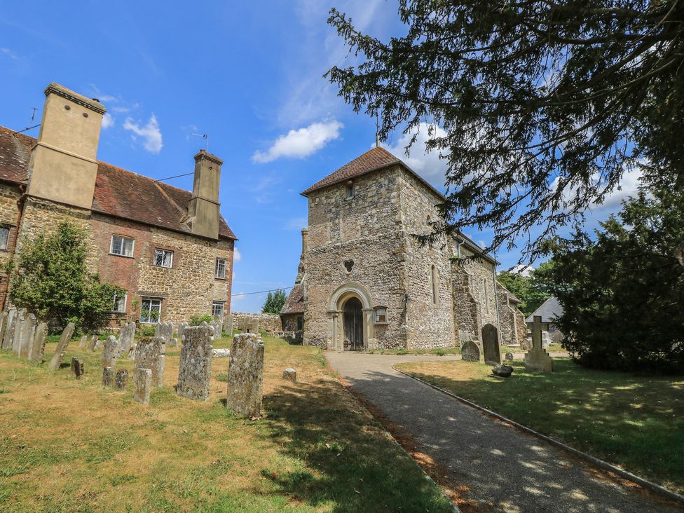 A church with a graveyard and pathway in Sullington near Storrington