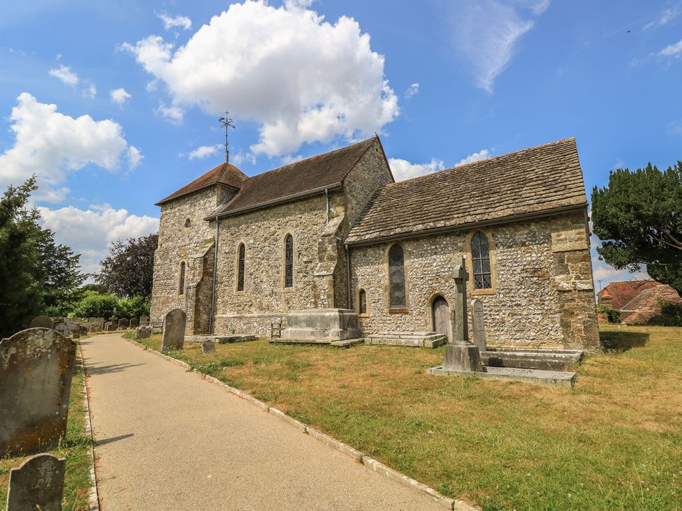 A church with gravestones in a graveyard near a pathway