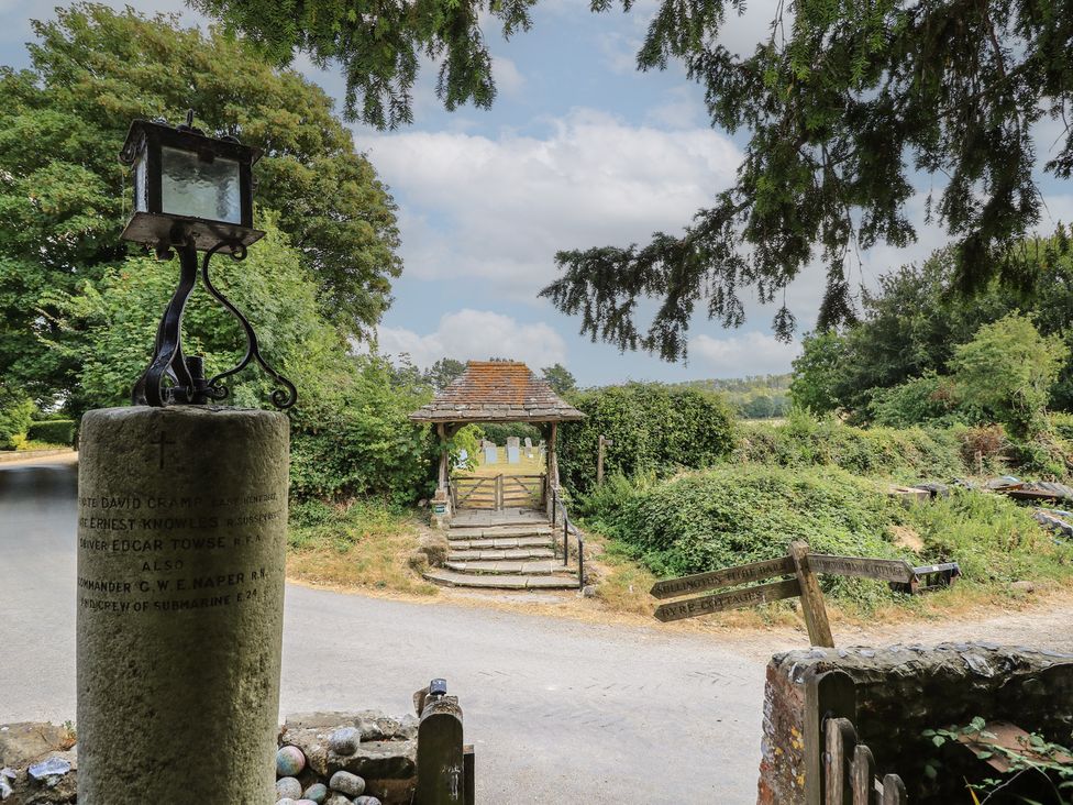 A pathway and memorial stone with a gate at Byre Cottage 2 Sullington near Storrington