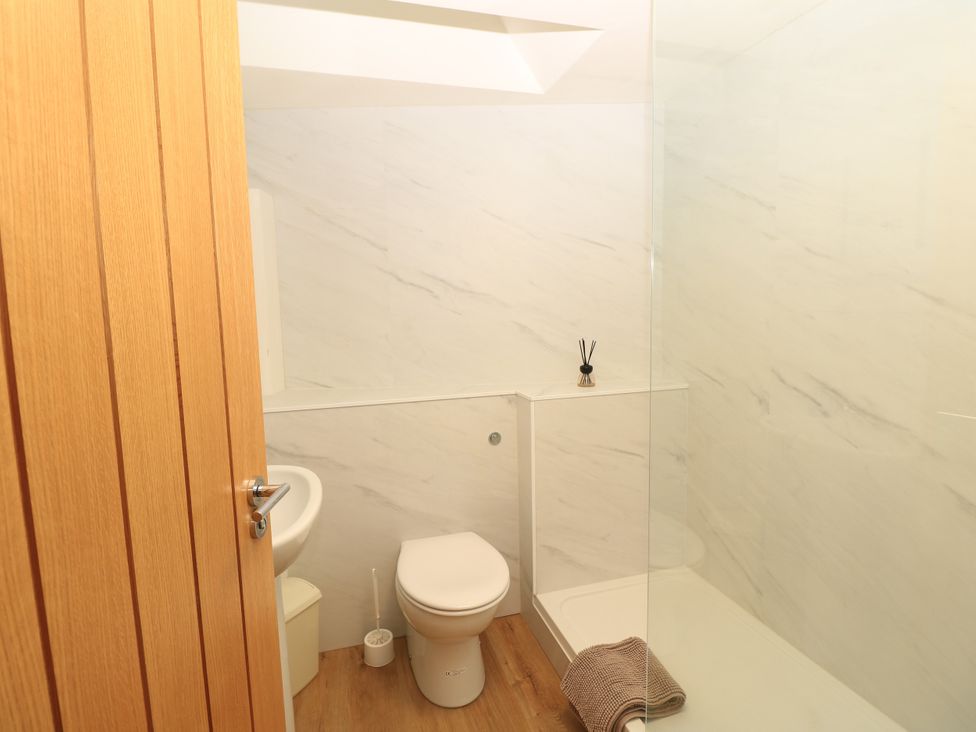 A bathroom with a toilet and shower at Byre Cottage 2 Sullington near Storrington