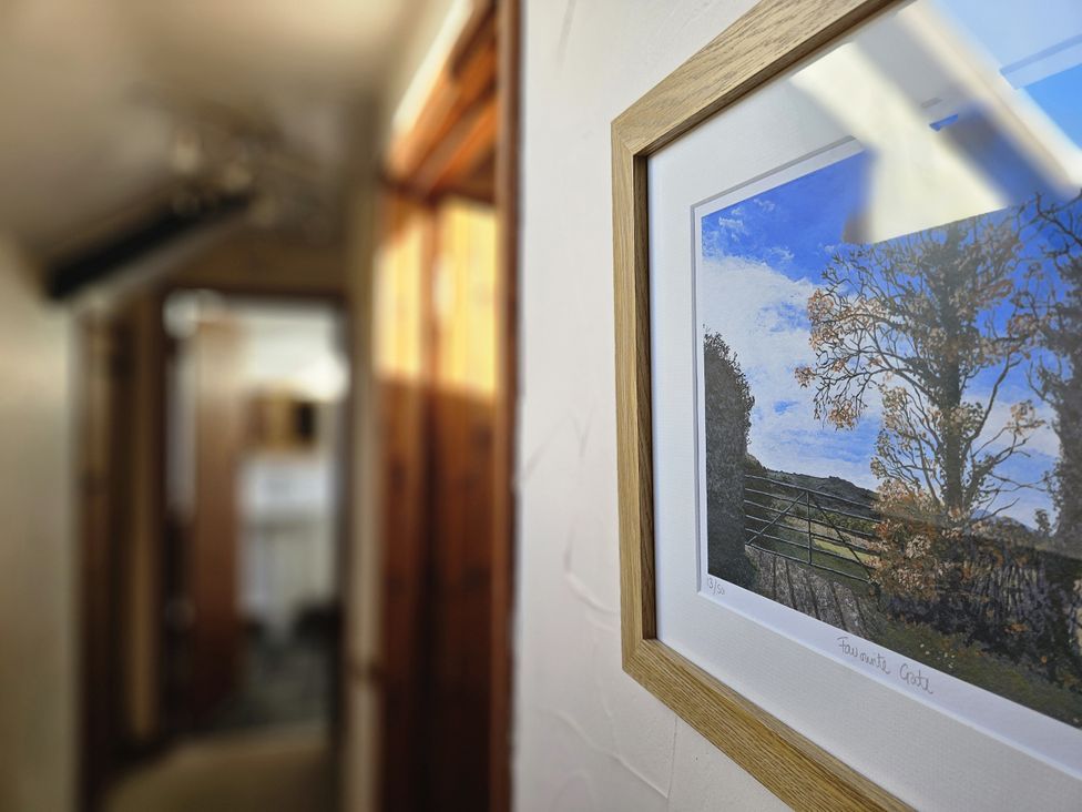 A hallway with a picture frame on the wall at The Old Dairy in Bridport