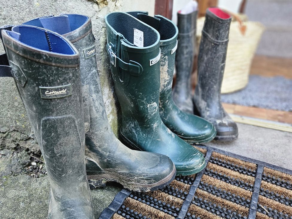 A pair of rubber boots on a doormat at The Old Dairy in Bridport