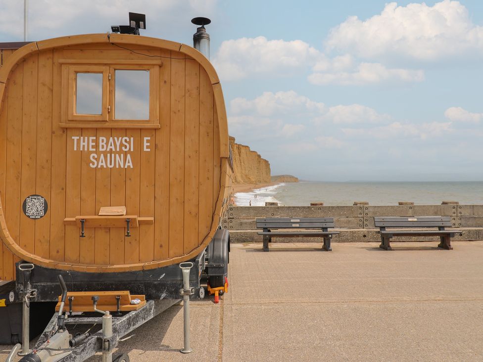 A sauna on a beachfront with benches and cliffs at The Bayside Sauna in 