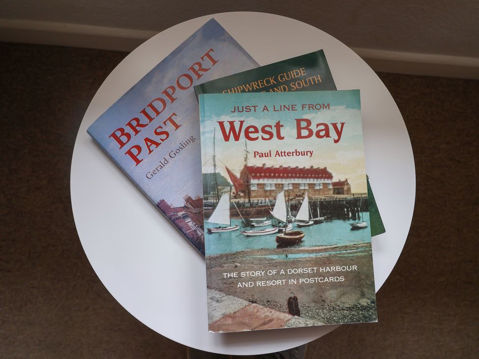 Three books on a table at Flat F Bay House in West Bay