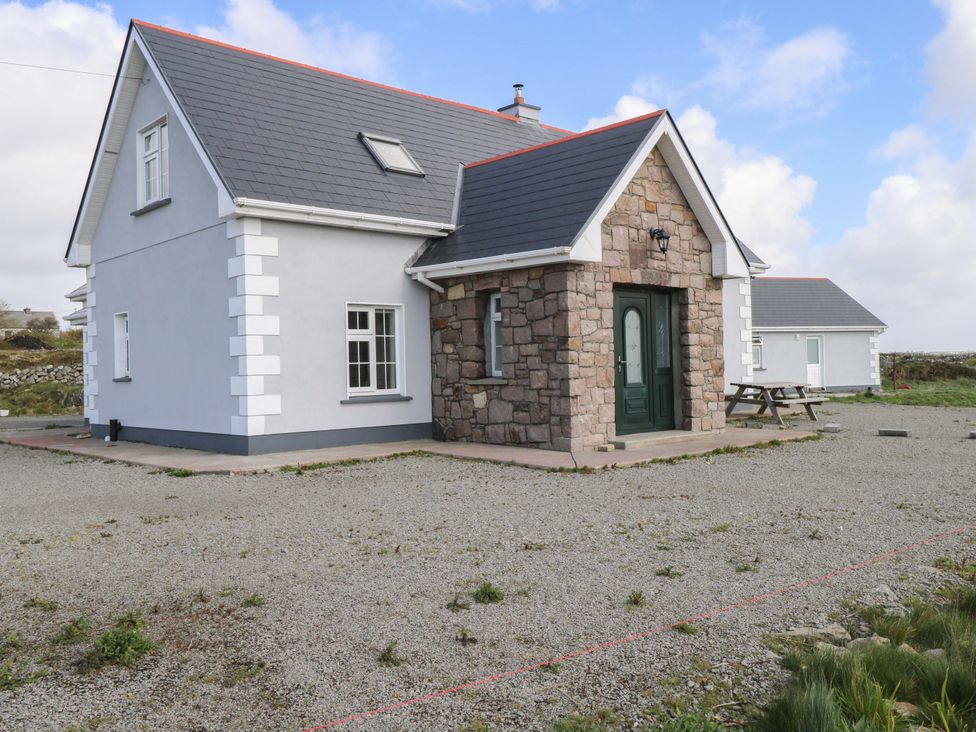 A house with a stone exterior and a gravel area at Tí Tom Nárta, Trabane near Lettermore, County Galway