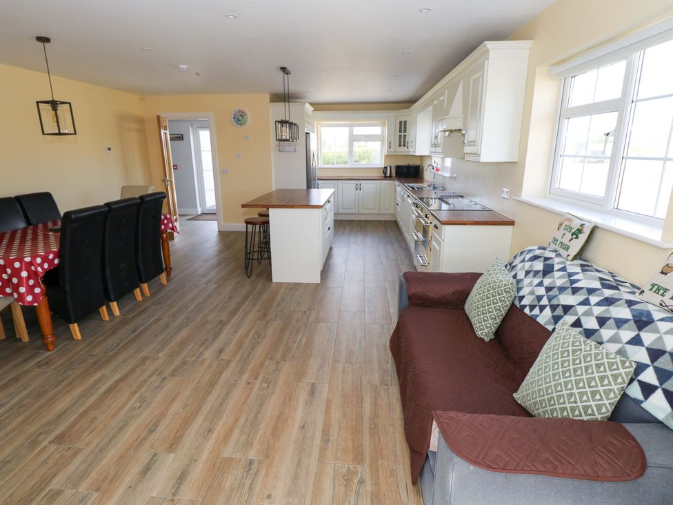 A kitchen with a dining area and seating at Tí Tom Nárta Trabane near Lettermore, County Galway