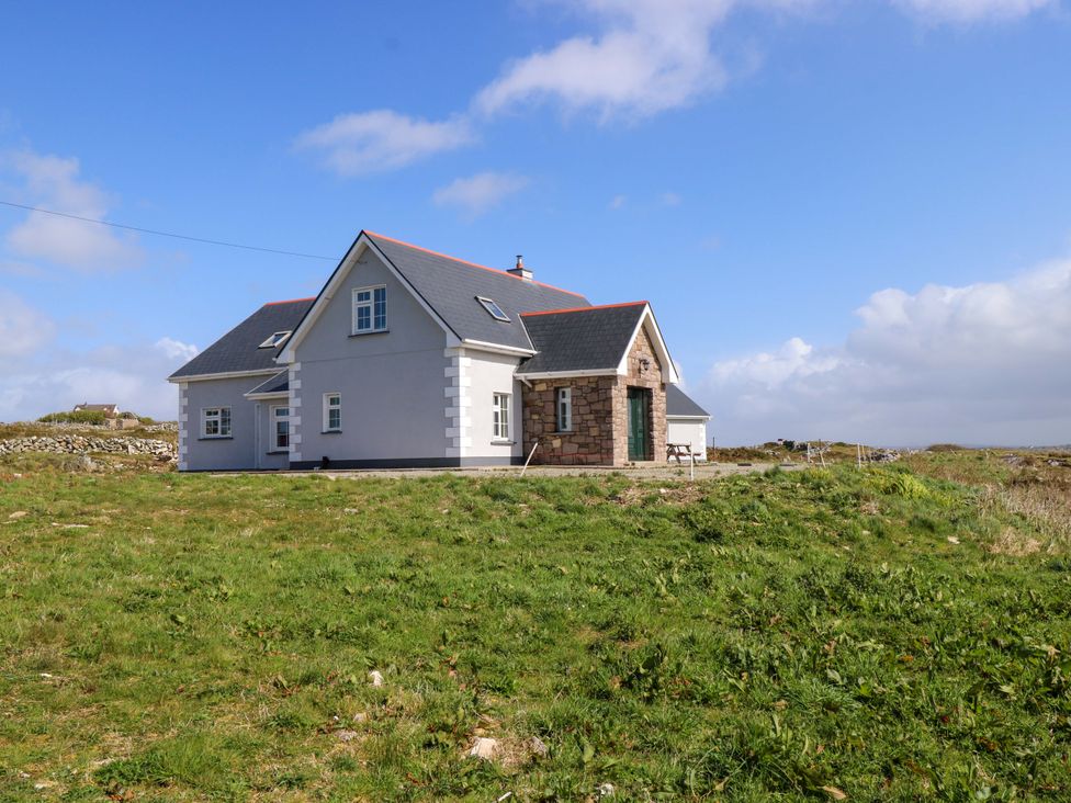 A house with a pitched roof and windows in an outdoor area at Tí Tom Nárta Trabane near Lettermore, County Galway