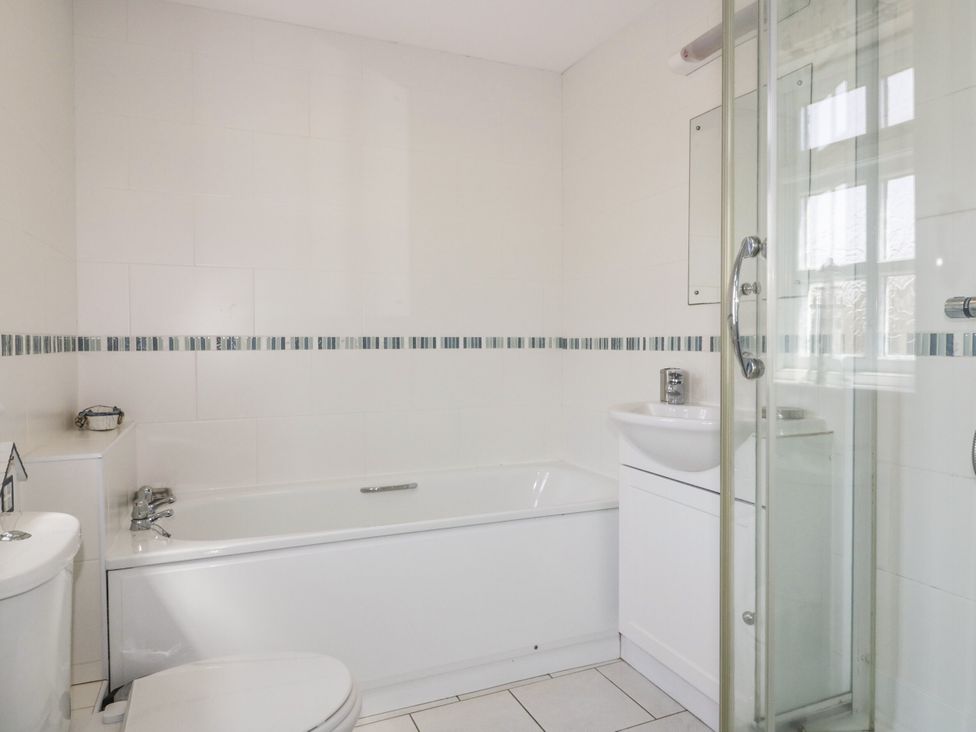 A bathroom with a bath, toilet, sink, and shower at Owls Roost in Gorran Haven